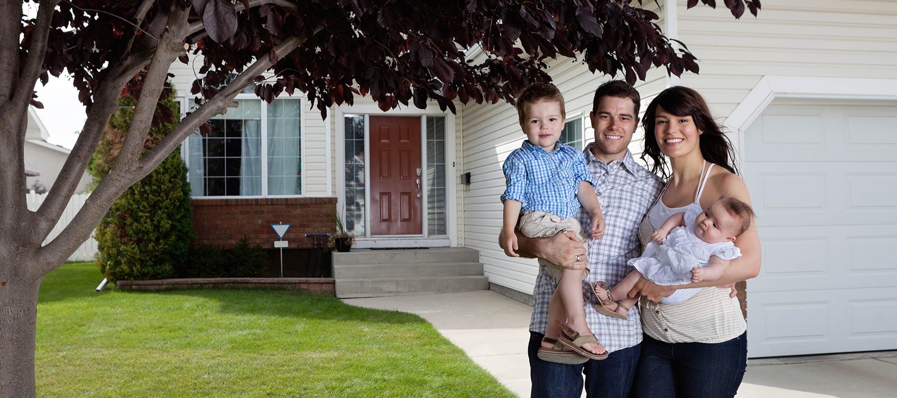 Family in front of new house